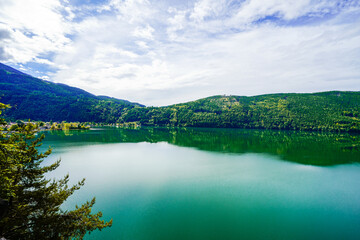 View of Lake Millstatt and the surrounding green landscape. Idyllic nature by the lake north of the Drava Valley near the town of Spittal an der Drau in Carinthia.

