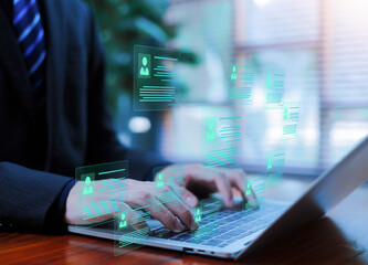 Businessman typing on laptop with virtual digital profile cards, online recruitment and human resources database concept, talent management, employee information system and HR technology interface.