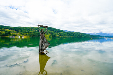 View of Lake Millstatt and the surrounding green landscape. Idyllic nature by the lake north of the Drava Valley near the town of Spittal an der Drau in Carinthia.
