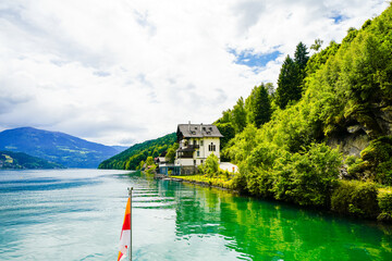 View of Lake Millstatt and the surrounding green landscape. Idyllic nature by the lake north of the Drava Valley near the town of Spittal an der Drau in Carinthia.
