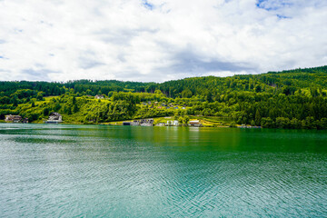 View of Lake Millstatt and the surrounding green landscape. Idyllic nature by the lake north of the Drava Valley near the town of Spittal an der Drau in Carinthia.
