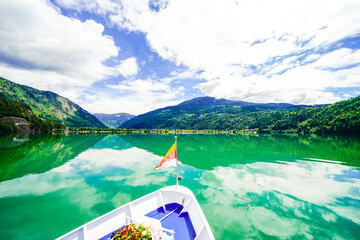 View of Lake Millstatt and the surrounding green landscape. Idyllic nature by the lake north of the Drava Valley near the town of Spittal an der Drau in Carinthia.
