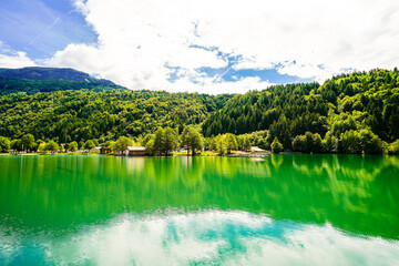 View of Lake Millstatt and the surrounding green landscape. Idyllic nature by the lake north of the Drava Valley near the town of Spittal an der Drau in Carinthia.
