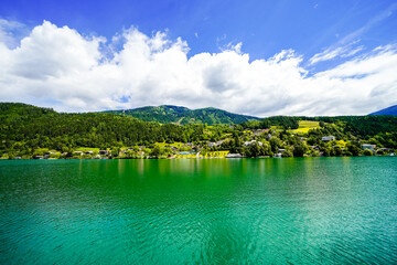 View of Lake Millstatt and the surrounding green landscape. Idyllic nature by the lake north of the Drava Valley near the town of Spittal an der Drau in Carinthia.
