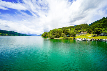 View of Lake Millstatt and the surrounding green landscape. Idyllic nature by the lake north of the Drava Valley near the town of Spittal an der Drau in Carinthia.
