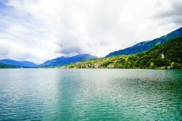 View of Lake Millstatt and the surrounding green landscape. Idyllic nature by the lake north of the Drava Valley near the town of Spittal an der Drau in Carinthia.
