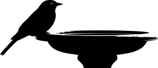 Silhouette of a Bird Resting on a Bird Bath in stark contrast
