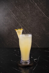 Yellow Cocktail with Lemon Garnish.