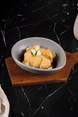 Bowl of Dumplings on Wooden Board.