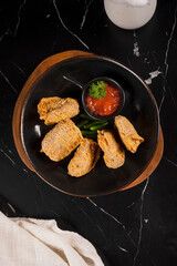 Breaded Fried Food with Red Sauce.