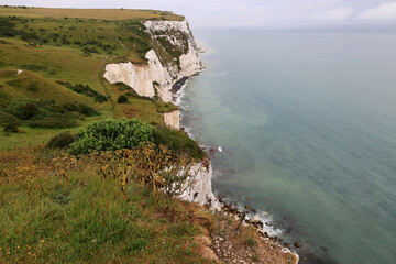 Landscape photo of the Dover chalk cliffs and the English Channel coastline right after the rain ends near Dover, United Kingdom	