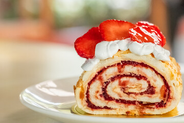 Swiss roll with strawberries. Cake slice cream with strawberry