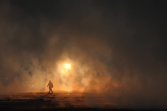 Man Walking Through Smoke and Light
