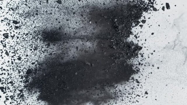 Super Slow Motion Flying and Colliding Crushed Coal Isolated On White Background at 1000 fps.