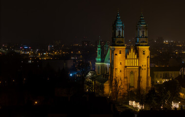 Fototapeta premium Aerial drone view of Cathedral Basilica of Saints Peter and Paul in Poznan in. Ostrow Tumski at night