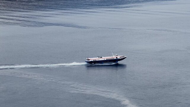 Fast hydrofoil ferry boat sailing in blue sea aerial view Corfu Greece travel transport