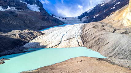 Athabasca glacier melting into turquoise lake in jasper national park