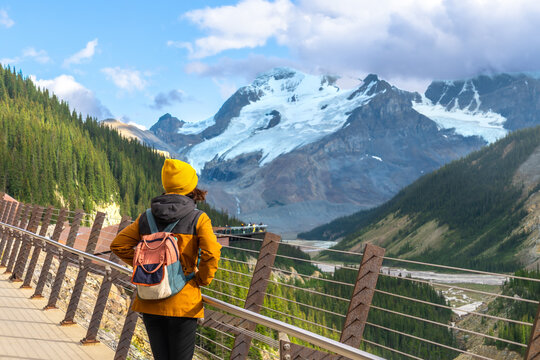 Tourist walking on the skywalk at the athabasca glacier in jasper national park