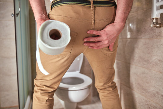 Man with urge to go to the toilet at home.
