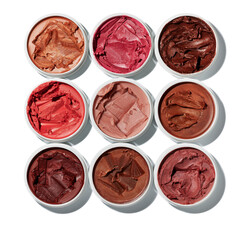 Assortment of nine individual cosmetic pots featuring richly pigmented vibrant cream makeup products arranged in a grid.