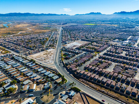 Aerial perspective of Los Angeles suburban housing development with arterial road and surrounding communities