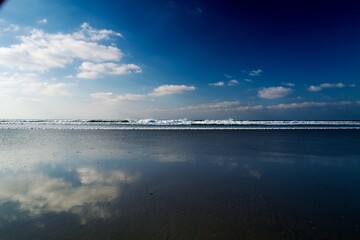 clouds over the sea at a picturesque scenery at a sandy coastline at Brittany, France