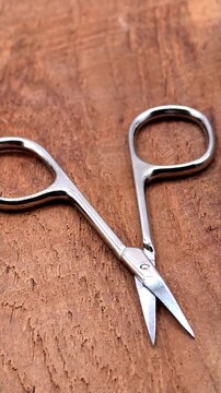 Scissors for cutting nails. Manicure, nail care, hygiene concept, vertical video