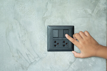 hand holding a light switch