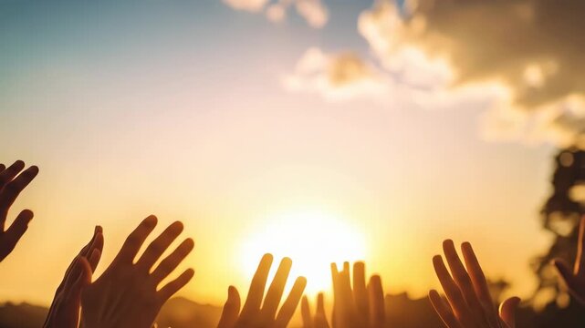 Group of people raising hands towards the sky at sunset, collective gesture of success, hope, gratitude, freedom and celebration, teamwork concept.