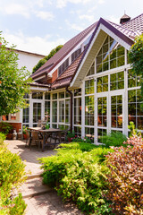 Sunlight shines on a garden with a house in the background