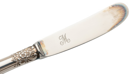 Ornate silver butter knife with floral engraving and monogram M silverware utensil