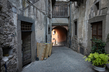 a narrow cobbled street with typical architecture in the medieval old town of Montefiascone, province of Viterbo, Lazio, Italy