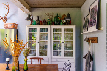 Kitchen with glassware and green decor in country home