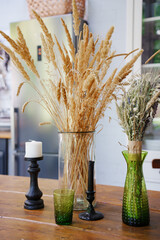 Decorative dried flowers and candles in home setting