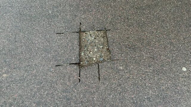 Place of selection of the kernel in the form of a rectangular from asphalt concrete pavement. Kern. Close-up

