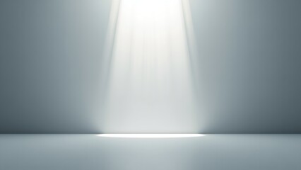 A bright light shines down in a gray room with a spotlight effect