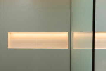 A modern recessed wall niche featuring integrated LED strip lighting 