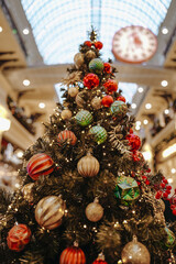 Christmas tree decorated with red gold festive Christmas balls and toys, New Year magic decor and details