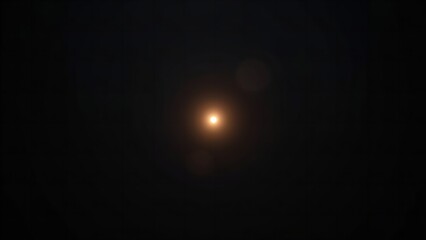 A bright light shines in the dark night sky