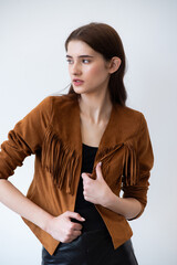 Obraz premium Beautiful fashion model in beige trench coat posing confidently in studio, professional female portrait for model agency portfolio, minimal clean background modern fashion concept