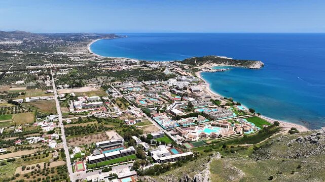 Aerial drone cinematic video of famous for luxury pool resorts and five star hotels seaside village of Kolymbia, Rhodes island, Dodecanese, Greece