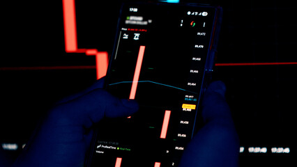 Financial charts and graphs on digital screens in dark office