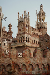 Historic monument blending diverse architectural styles, featuring ornate towers and intricate stonework in Benalmadena, Spain, captured to highlight its cultural significance and unique design