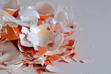 Pile of broken egg shell on white background. Concept of cooking baking food waste and kitchen debris.