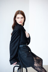 Professional fashion model wearing stylish beige trench coat posing in studio, full length female portrait for modeling agency portfolio, commercial beauty and modern style photography