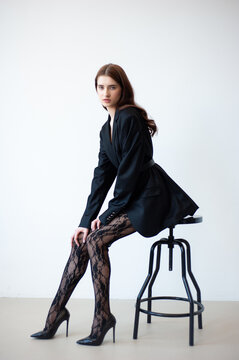 Professional fashion model wearing stylish beige trench coat posing in studio, full length female portrait for modeling agency portfolio, commercial beauty and modern style photography