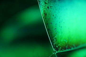 Green liquid surface, phenomenal structure, green oils on a dark background, colourful luminous abstract, surrealistic art, glowing effects