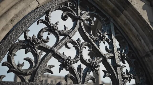 Extremely slow motion detailed close-up pan across intricate cast iron filigree decorating a large ornamental gate and gothic arch structure vintage, decorating, detailed