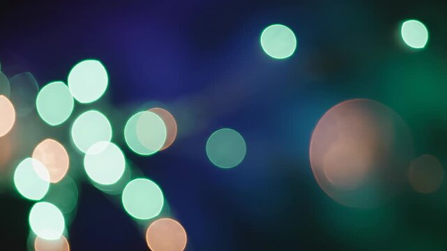 Extremely slow motion macro shot of soft, blurry mint green and copper bokeh lights floating and fading across a deeply saturated atmospheric backdrop commercial, orange, seamless