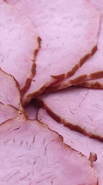 Sliced pork ham texture close-up. Food background, vertical video